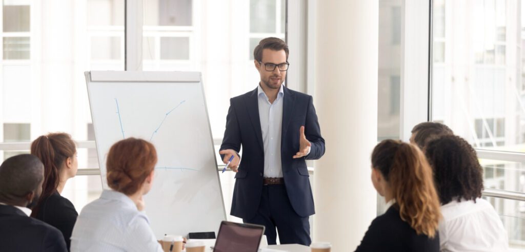 Male business coach speaker in suit give flipchart presentation